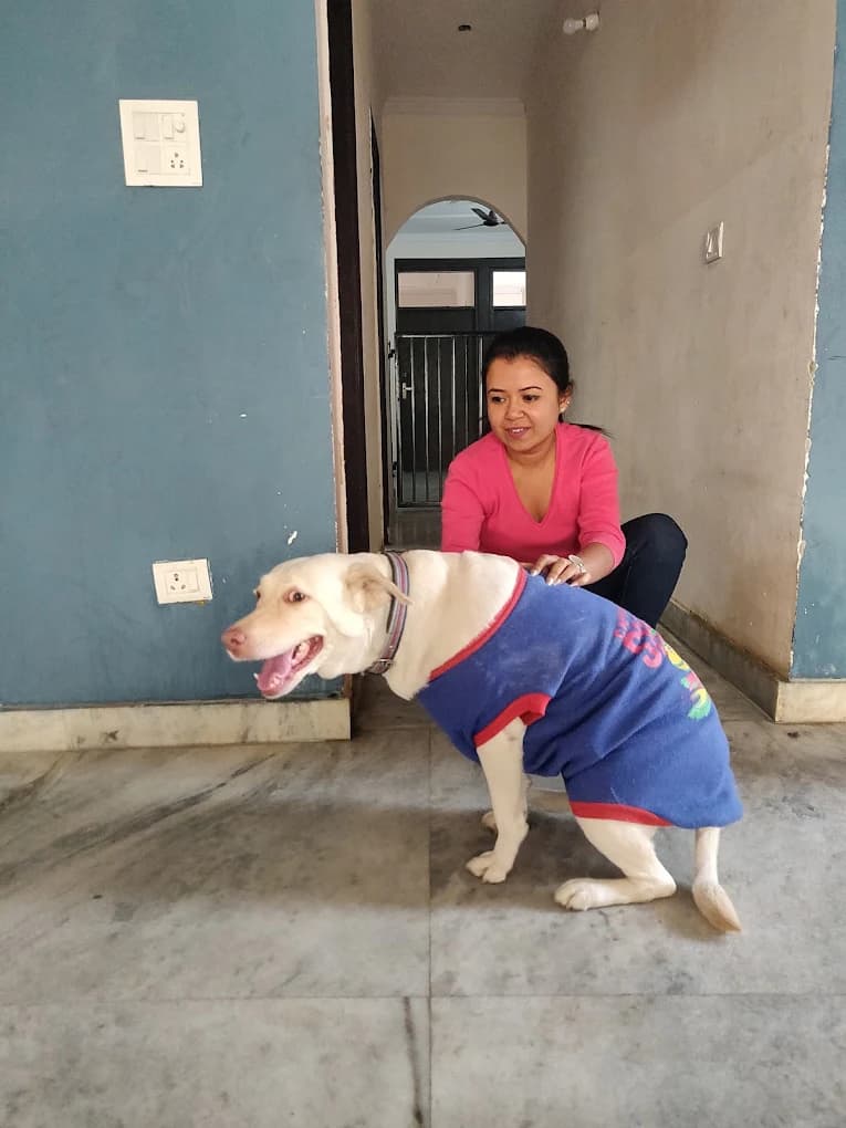 Woman with white dog in blue shirt